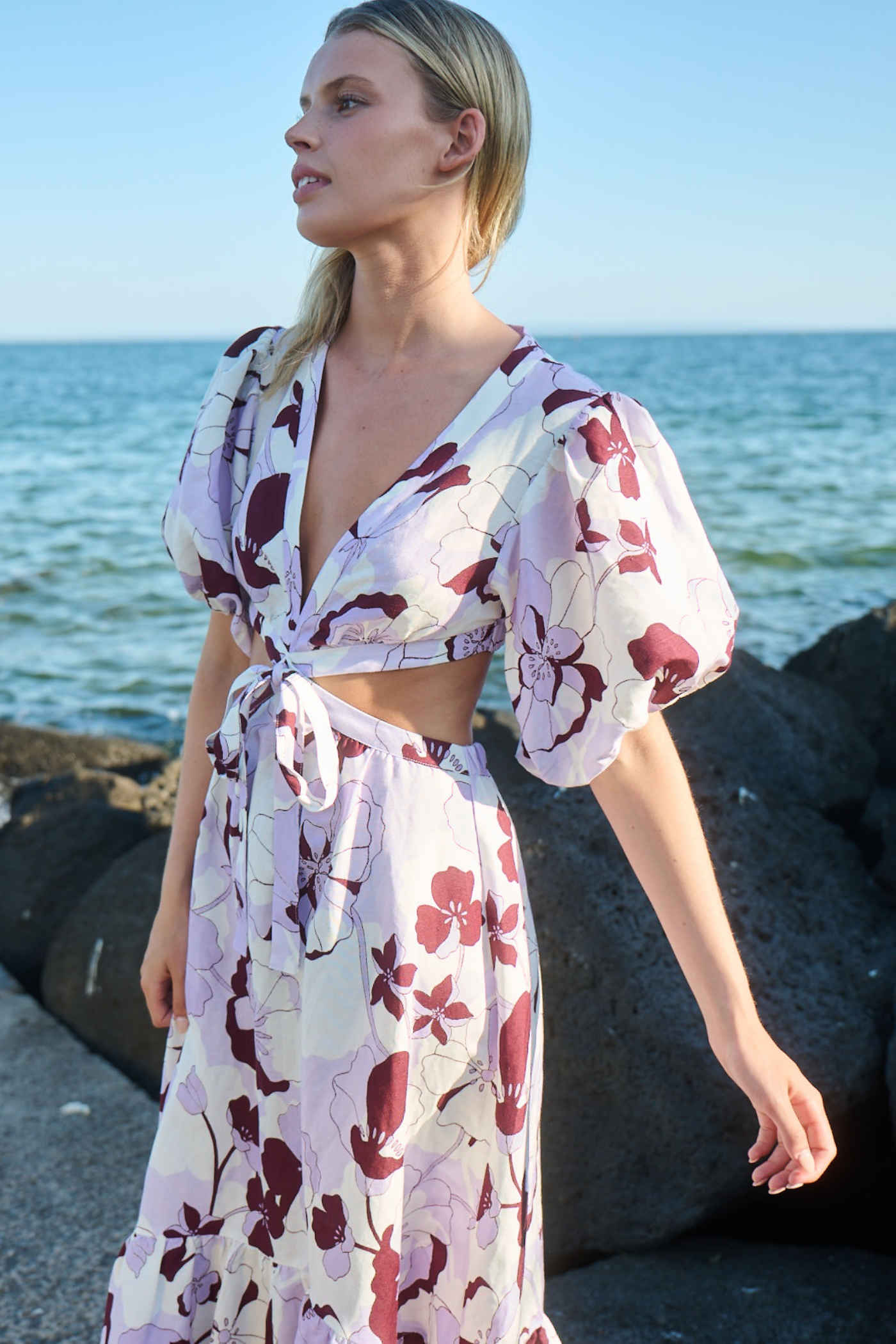 model posing in short sleeve cut out dress