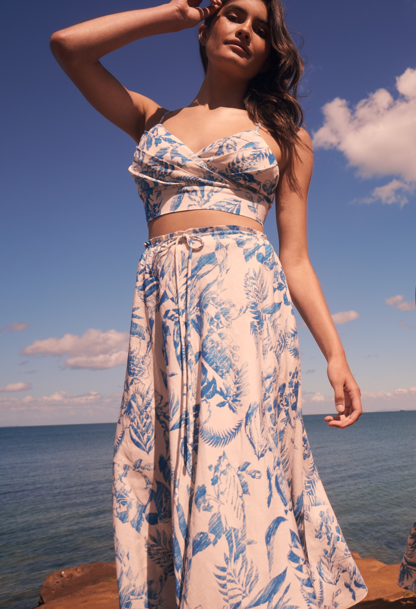 Woman wears printed linen midi skirt with tie waist