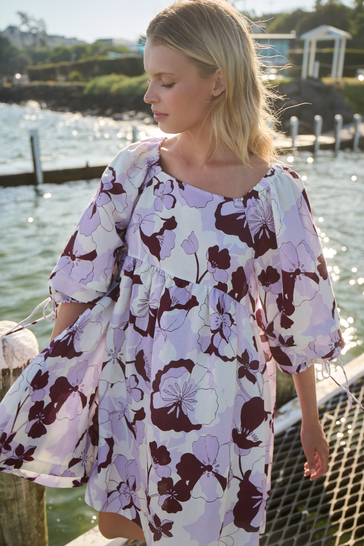 girl by the water wearing linen dress