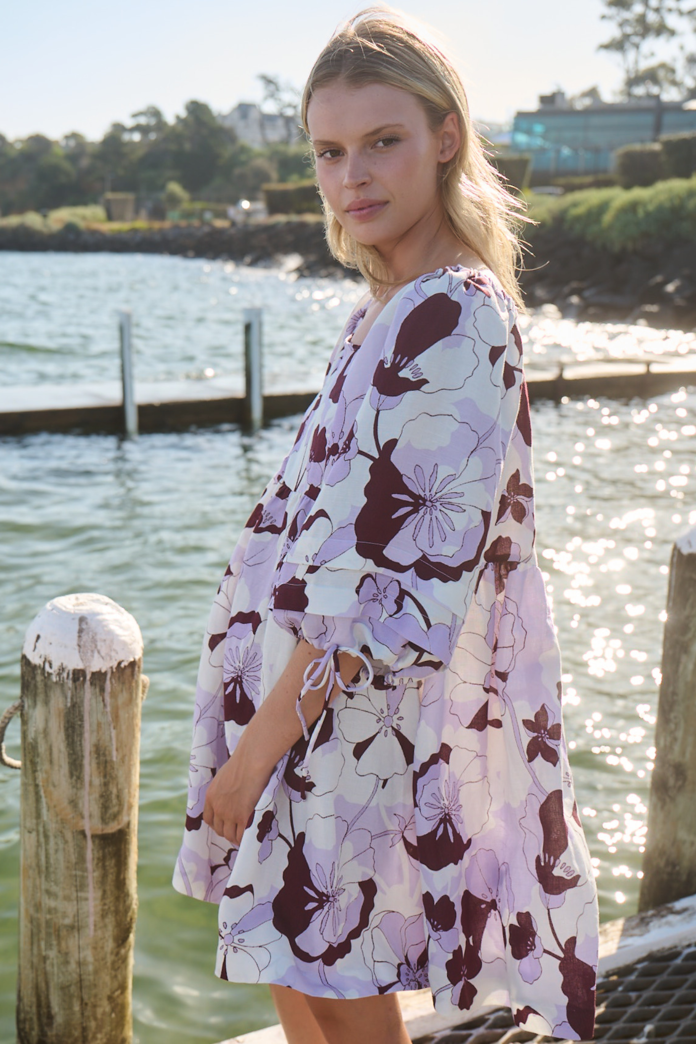 blonde woman wearing lilac print dress