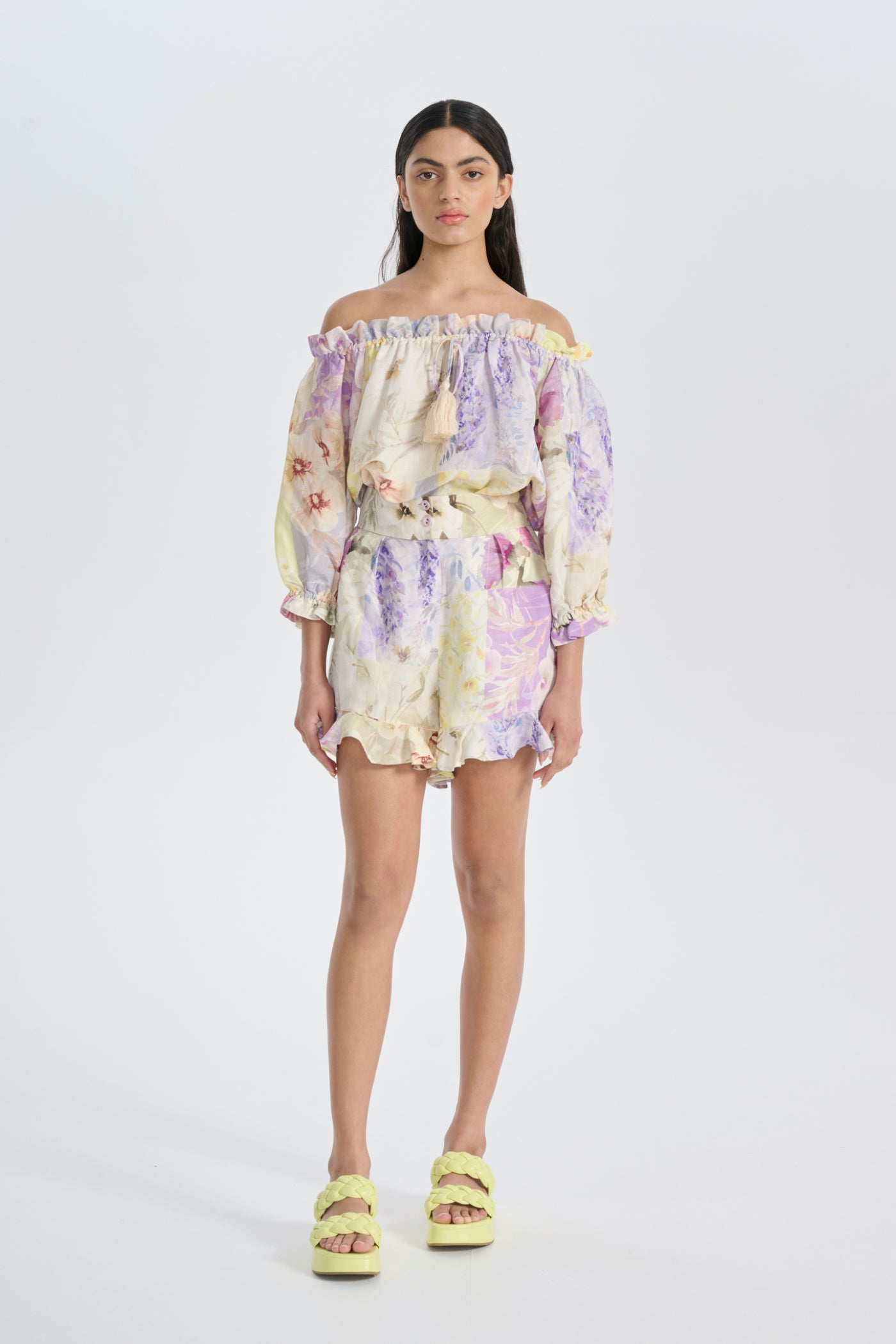 woman wears floral printed pastel outfit