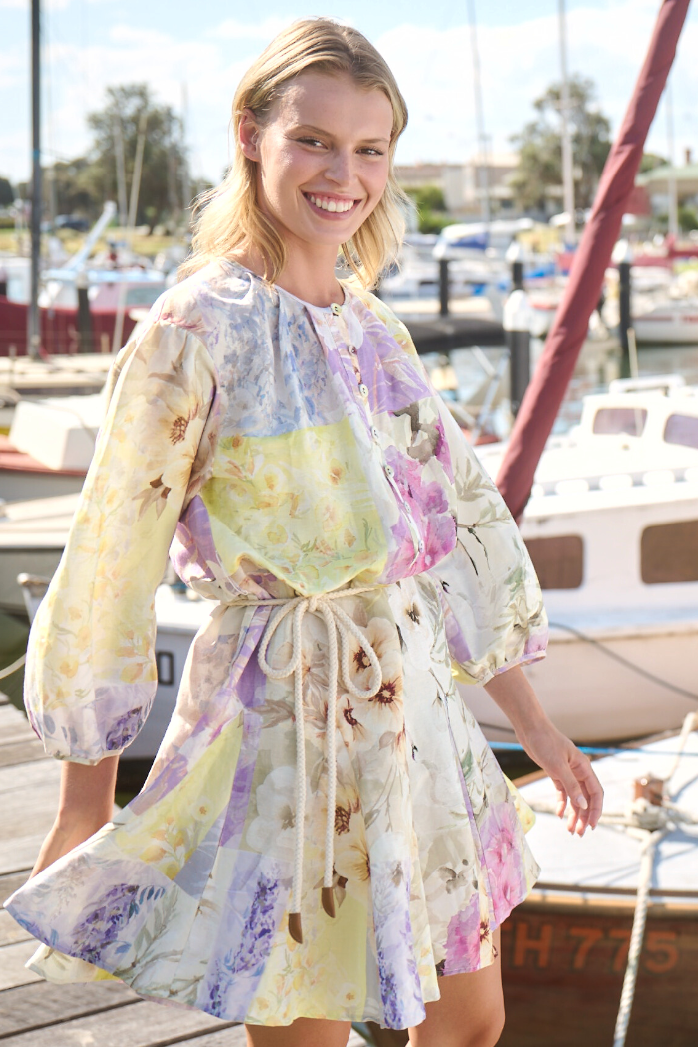 girl wearing long sleeve dress smiling