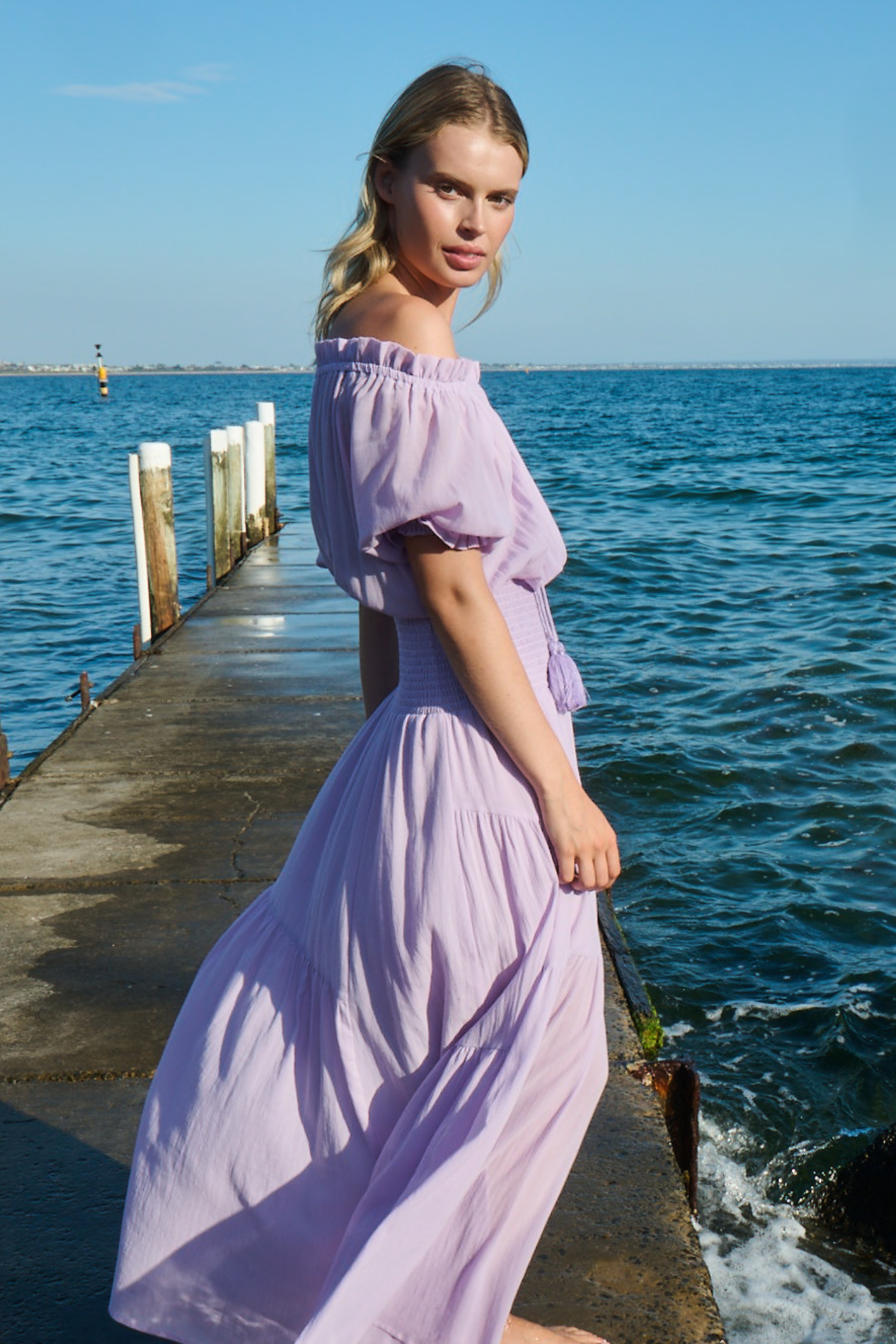 woman wearing off shoulder dress at the beach