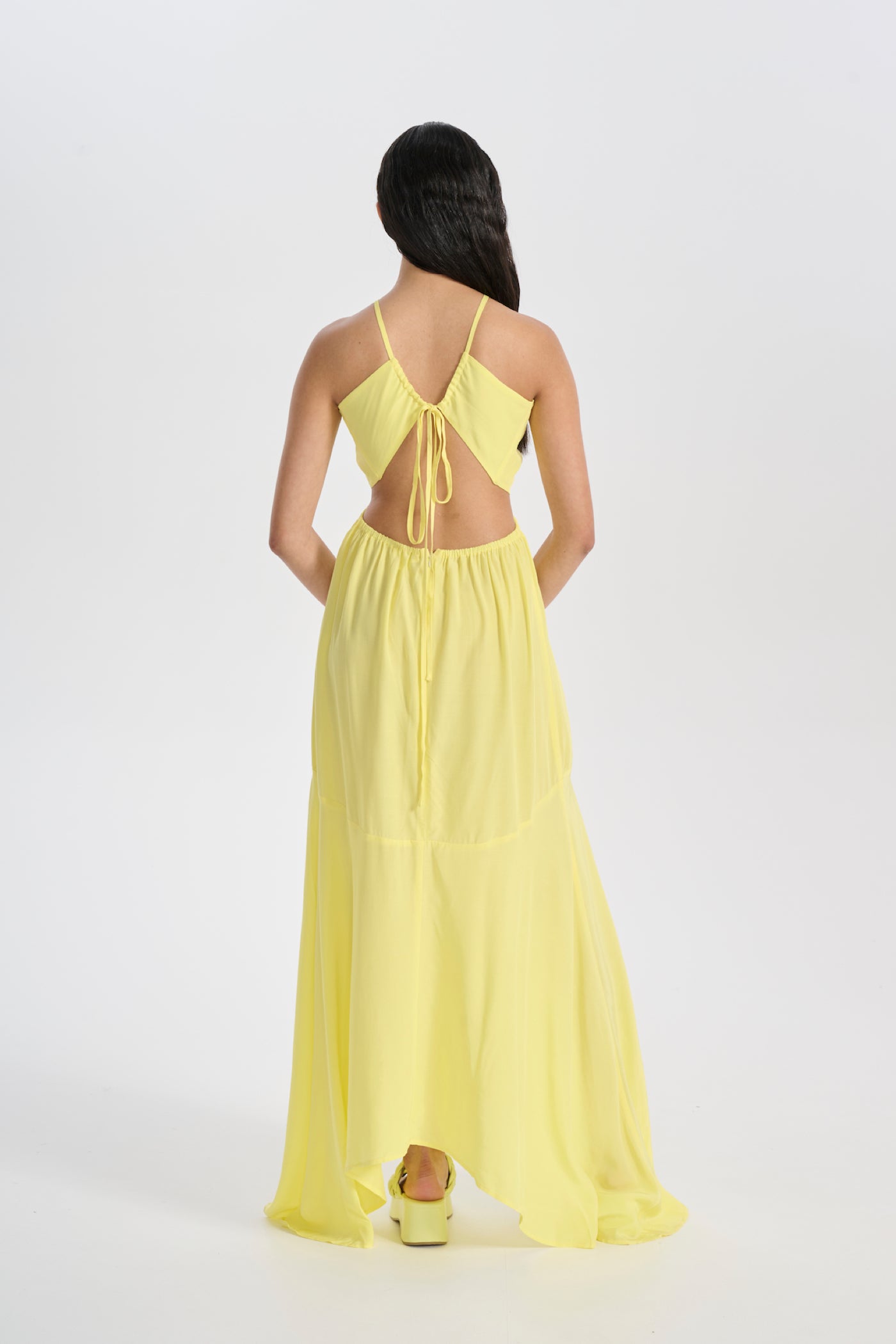 Model in backless yellow tie up maxi dress