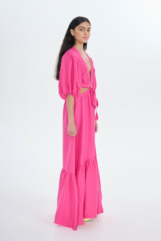 Model wearing pink maxi dress with cut outs