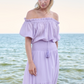 model wearing lilac maxi dress near water