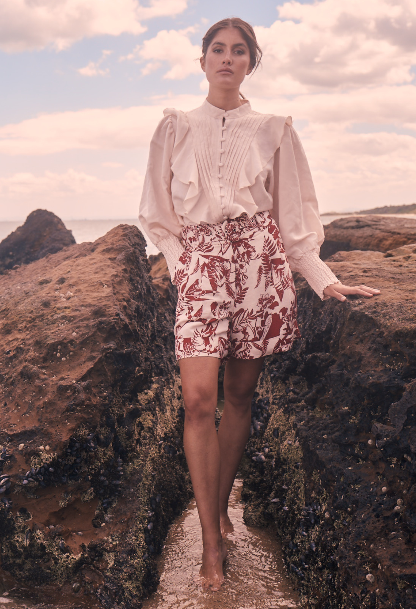 Model at the beach wearing tailored linen shorts matching co ord set