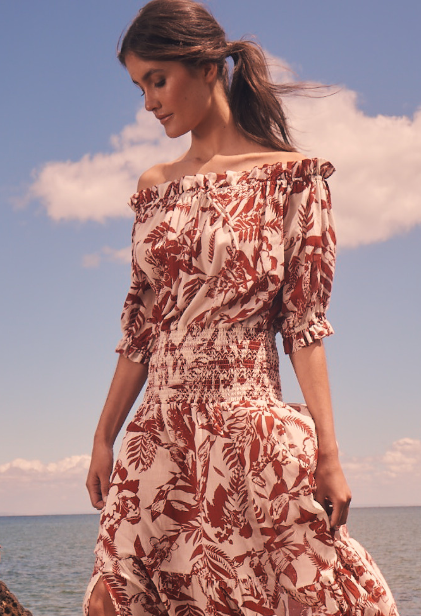 Model at beach wearing off shoulder maxi dress