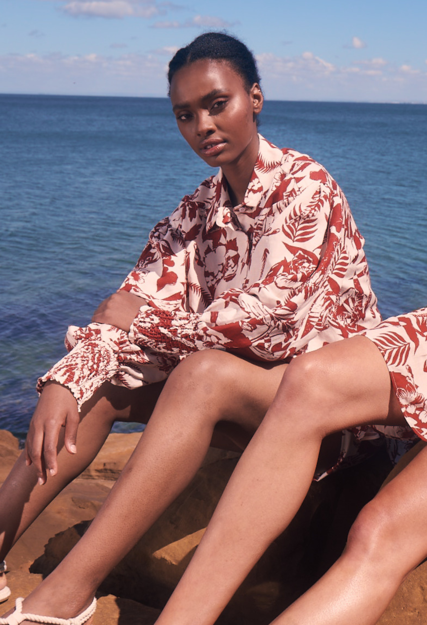 Model wears floaty cotton top red white tropical print