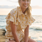 girl smiling wearing matching short top set