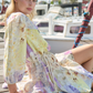 Model posing on boat pier wearing short dress