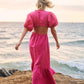 model wearing pink maxi dress at beach