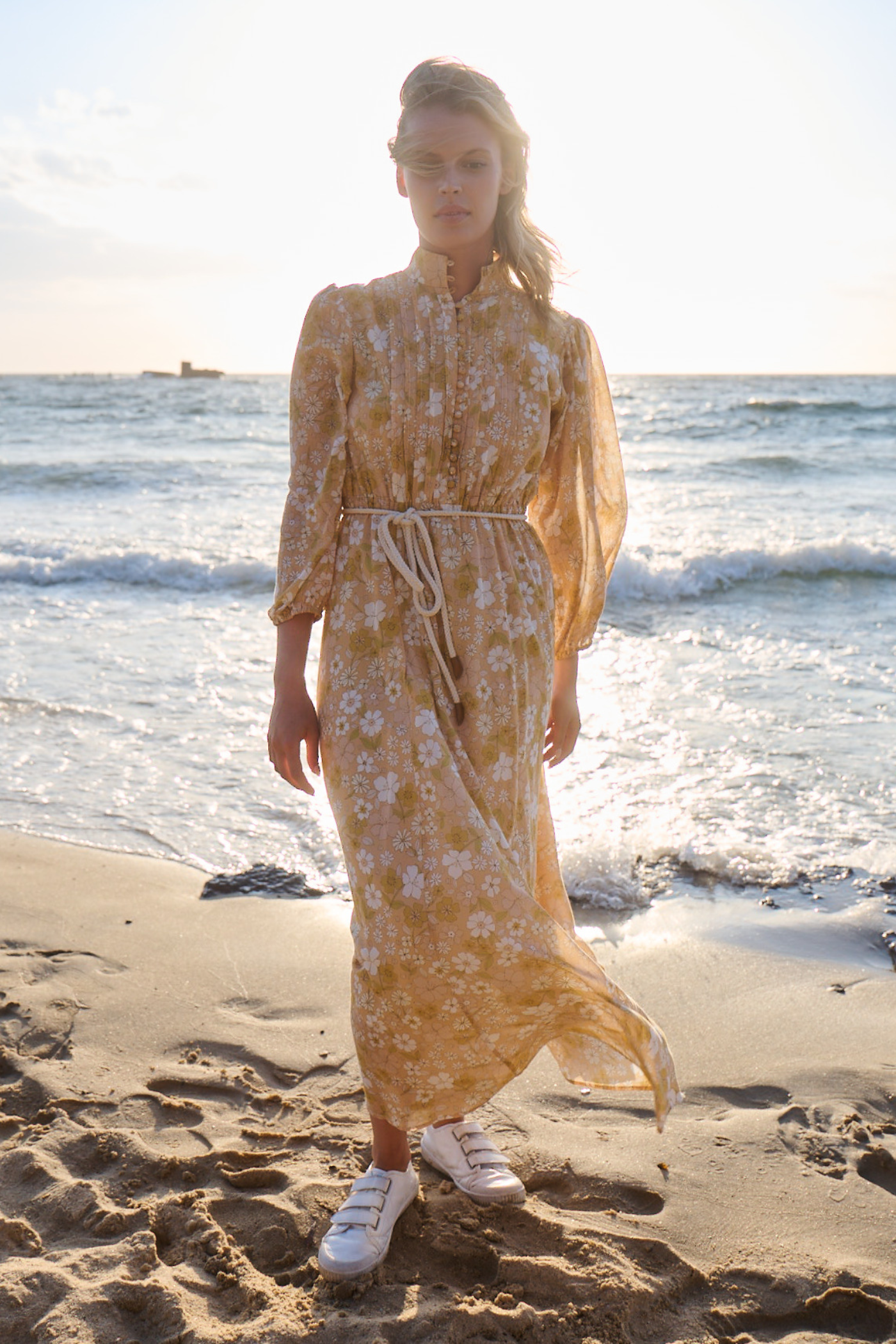 woman wearing printed maxi dress on the beach