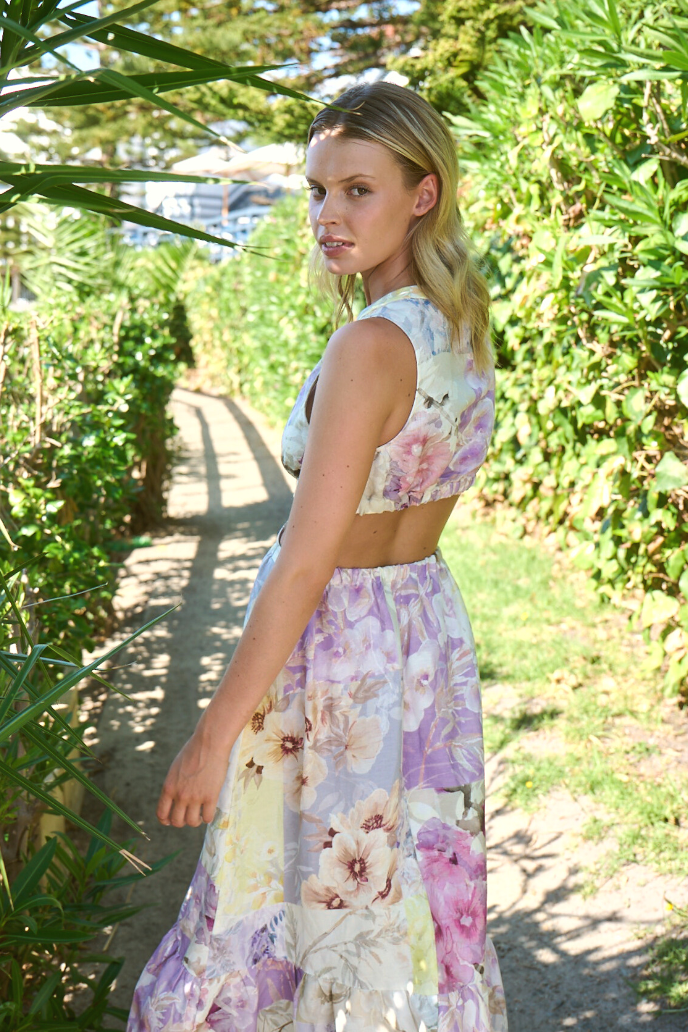 model wearing long backless dress in garden