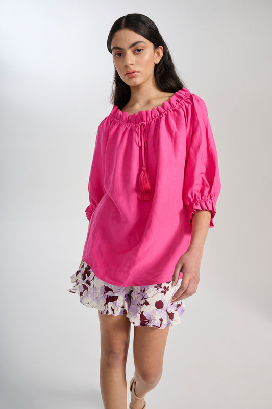 Model wears floaty blouse in pink